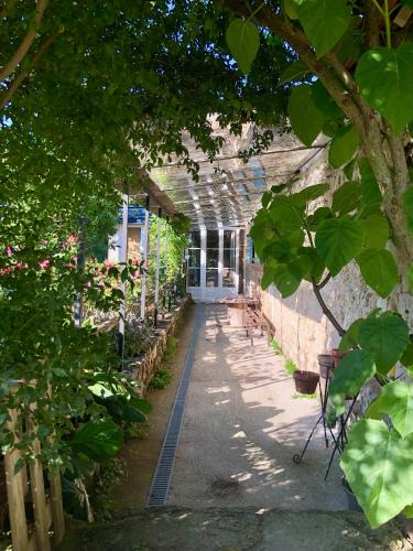 a building with a greenhouse with plants in it at Chambre d'Hôtes chez Gustave & Compagnie in Choussy