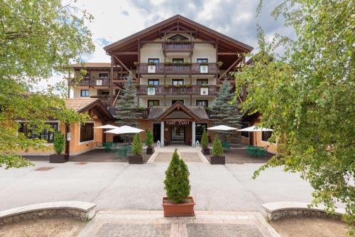 an exterior view of a lodge with a building at Golf Hotel in Folgaria