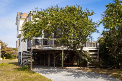 a house with a deck and a tree at Oceanside Cottage -3BDR 2BA-Walk to Beach! in Kill Devil Hills