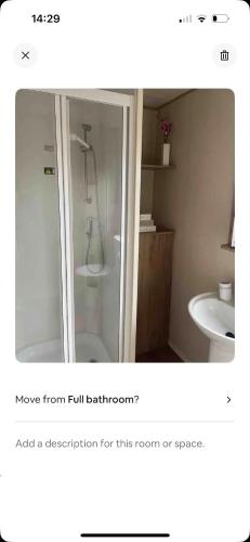 a bathroom with a shower and a sink at AJ’s Caravan Hire in Aberystwyth