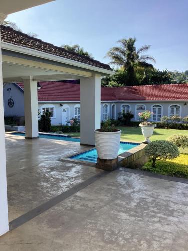 a house with a swimming pool in a yard at Hudson Haven Bed & Breakfast in Pietermaritzburg