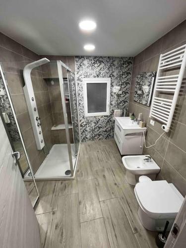 a bathroom with a shower and a toilet and a sink at Appartamento vista mare in Agnone Bagni