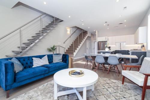 a living room with a blue couch and a table at Breathtaking Downtown Penthouse B - Sleeps 11 in Chicago