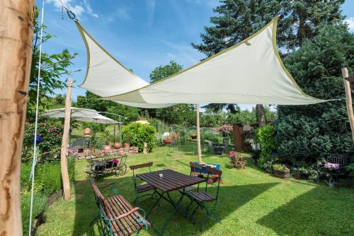 a white umbrella over a table in a yard at Fewo Odenwald - Marie in Breuberg