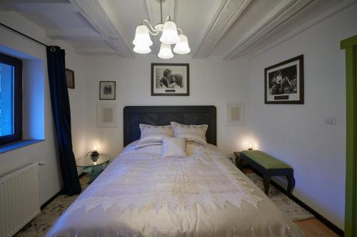 a bedroom with a large bed with two lamps at Chalet & Spa Maestrul si Margareta in Buşteni
