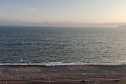 a view of the ocean on a cloudy day at Acogedor Departamento de estreno frente al mar in Lima