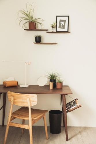 a wooden desk with plants on the wall at Boy apartment -Adult only in Hualien City