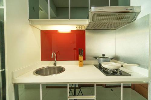 a kitchen counter with a sink and a stove at Stylish & Cozy Studio in central Jakarta, SCBD in Jakarta