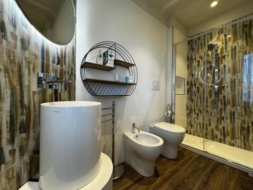 a bathroom with a sink and a toilet and a shower at SKYLINE Siena in Siena