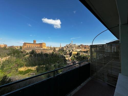 a view of a city from a balcony at SKYLINE Siena in Siena