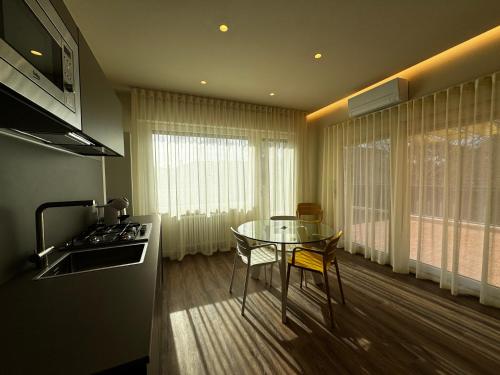 a kitchen with a glass table and a stove at SKYLINE Siena in Siena