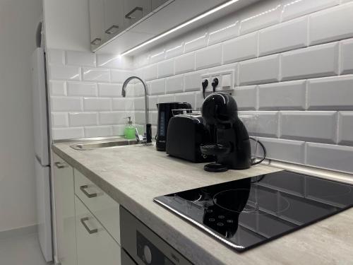 a kitchen counter with a sink and a microwave at Smart Hotel Budapest in Budapest