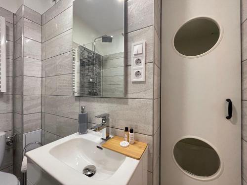 a small bathroom with a sink and a mirror at Smart Hotel Budapest in Budapest