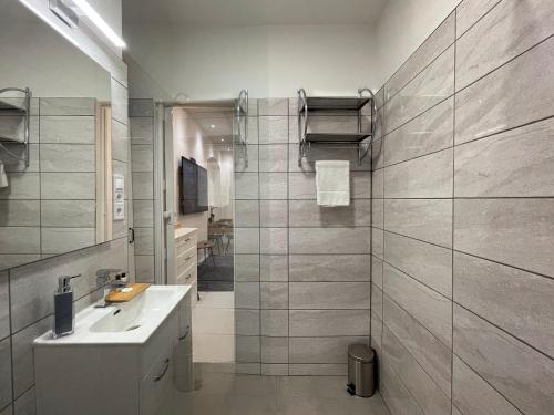a bathroom with a sink and a shower at Smart Hotel Budapest in Budapest
