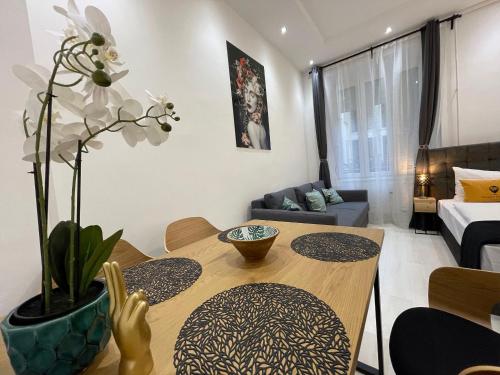 a small living room with a table and a couch at Smart Hotel Budapest in Budapest