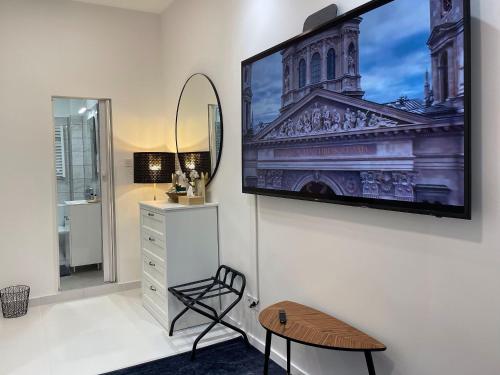 a living room with a flat screen tv on a wall at Smart Hotel Budapest in Budapest