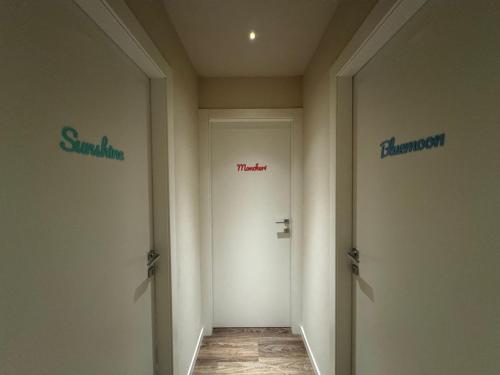 a hallway with two signs on the walls of a room at SKYLINE Siena in Siena