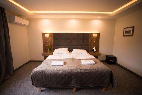 a bedroom with a large bed with two towels on it at Na Górce in Przemyśl