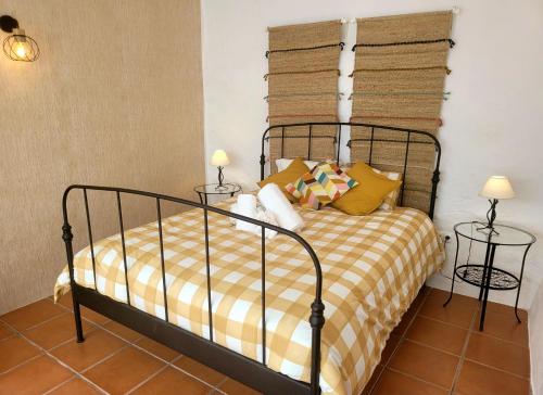 a bedroom with a bed and two lamps on tables at Casa da Chaminé - A Casa da Chaminé "torta" in Amieira