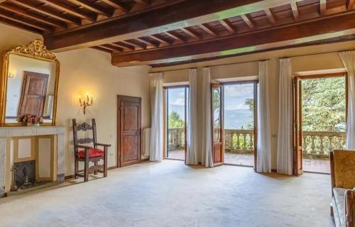 an empty living room with a fireplace and sliding glass doors at Agriresort & Spa Fattoria I Ricci in Vicchio