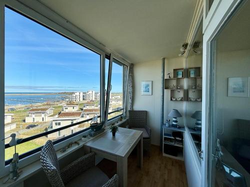 una stanza con un tavolo e una grande finestra di Ferienwohnung Fördeblick 7605 in Marina Wendtorf a Wendtorf