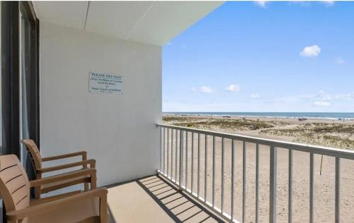 a room with a balcony with a view of the beach at Beau Rivage Beach Resort in Wildwood Crest