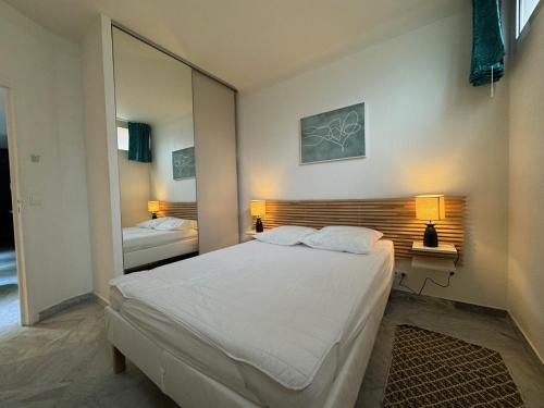 um quarto com uma cama grande e um espelho em Esperance em Cannes