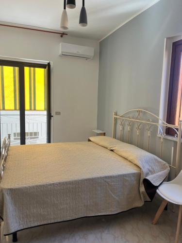 a bedroom with a bed in a white room at Piccola Mansarda in Parghelia