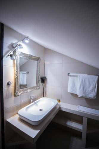 a bathroom with a sink and a mirror and towels at Na Górce in Przemyśl