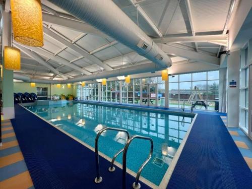 a large swimming pool in a large building at The Family Van - Withernsea in Waxholme