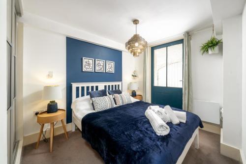 1 dormitorio con 1 cama con toallas en Riverside 1 Bed Flat near Hampton Court Palace en East Molesey