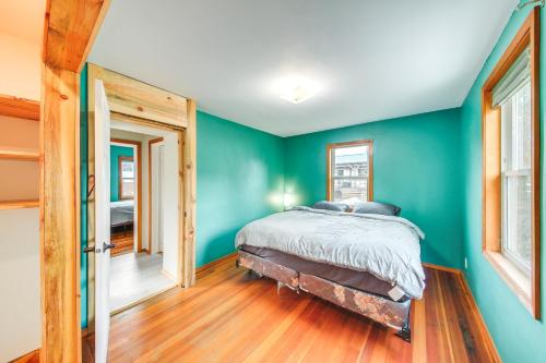 a bedroom with blue walls and a bed in it at Clark Fork Vacation Home with Wood Stove Near Lake! in Clark Fork