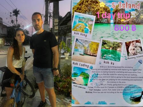 a man and a woman standing next to a sign at Lamai Home1 in Ko Yao Noi