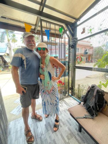 a man and a woman standing in front of a gate at Lamai Home1 in Ko Yao Noi