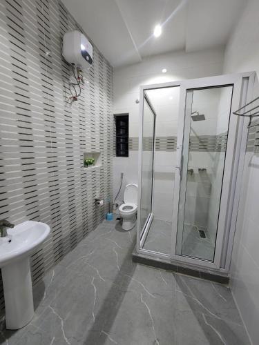 a bathroom with a shower and a toilet at Samuel Court in Abuja