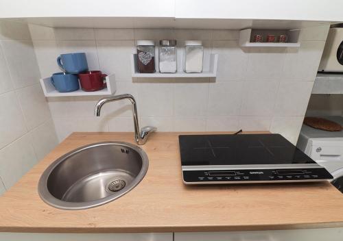 a kitchen counter with a sink and a laptop at Ale&Anda in Trani