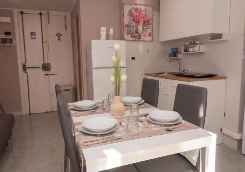 a kitchen with a table with plates and dishes on it at Ale&Anda in Trani