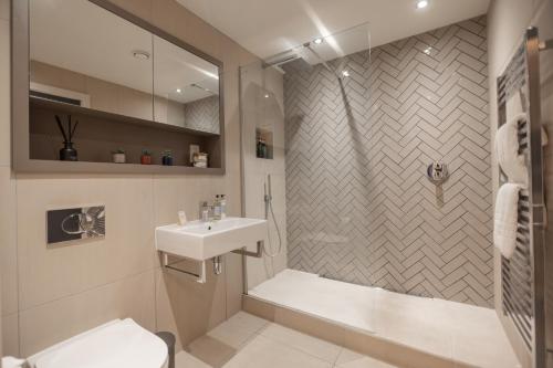 a bathroom with a shower toilet and a sink at King's 23 in York