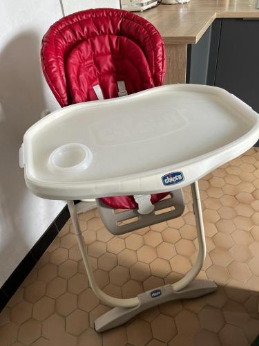 a red high chair sitting in a kitchen at maison bretonne 7 personnes in Mellac