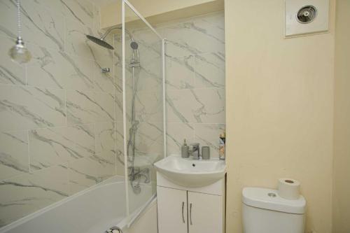 a bathroom with a sink and a shower and a toilet at London's Calling You! 2 Bed Lovely Home Sleeps 1-5! in Thamesmead