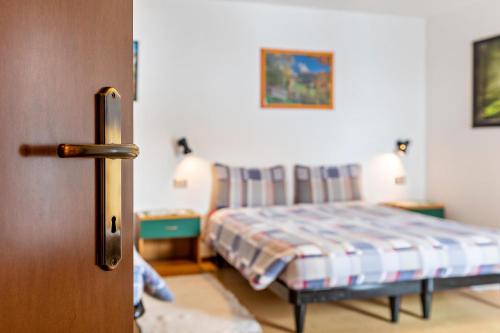 a bedroom with a bed in a room with a door at Agriturismo El Cirum Pelmo in Livinallongo del Col di Lana