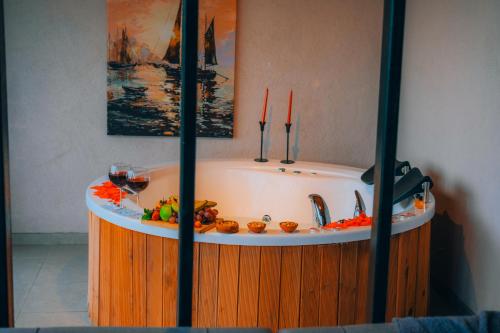 a bath tub filled with food and a glass of wine at Mouna Sapanca in Sapanca