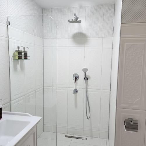 a shower with a glass door in a bathroom at Pertevniyal Aziziye Hotel in Konya