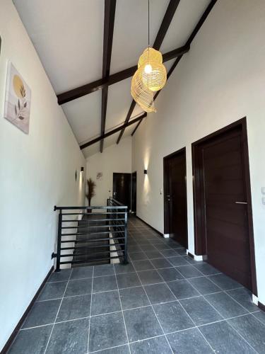 a hallway with a door and a chandelier at Eleven villa 2 in Pangandaran