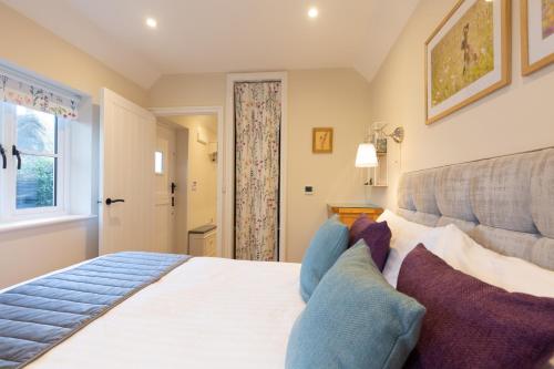 a bedroom with a large white bed and a window at The Lily Pad Suffolk in Thornham Magna