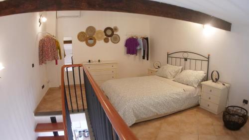 a bedroom with a bed and a stair case at La Casina di Chloe in Livorno