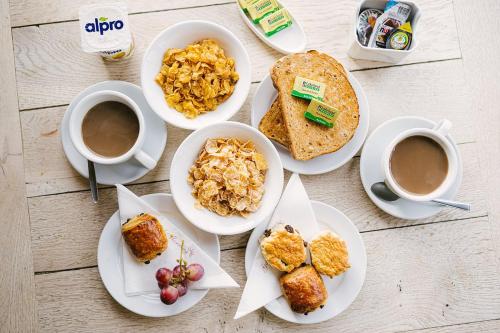 a table with plates of food and cups of coffee at The Mortal Man Inn in Troutbeck