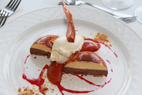 a plate of dessert with chocolate and ice cream at Skjoldenæsholm Slot in Jystrup
