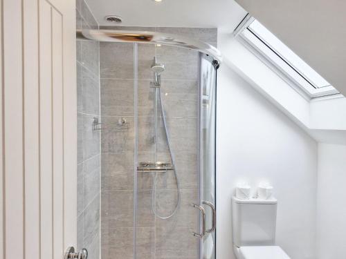 a shower in a bathroom with a toilet at Castleton , Chichester in Chichester