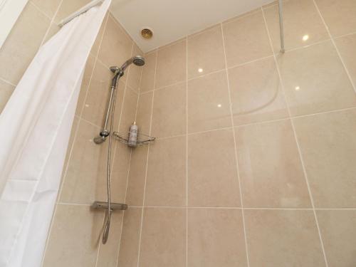 a shower with a shower curtain in a bathroom at 14 Berwick Road in Lytham St Annes